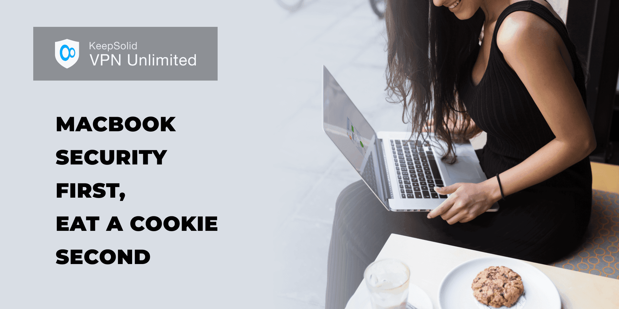 Smiling young business woman trying to keep macBook computer secure and eating a cookie while sitting in coffee shop in fresh air during breakfast