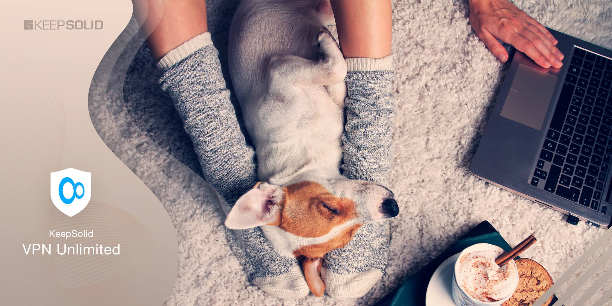 Woman in cozy home wear relaxing at home with sleeping dog Jack Russel terrier, drinking cacao, using laptop with VPN installed